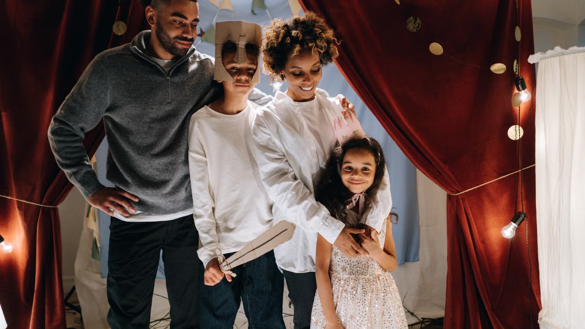 A family enjoying a playful theater night at home with kids dressed as actors. Warm and joyful atmosphere.